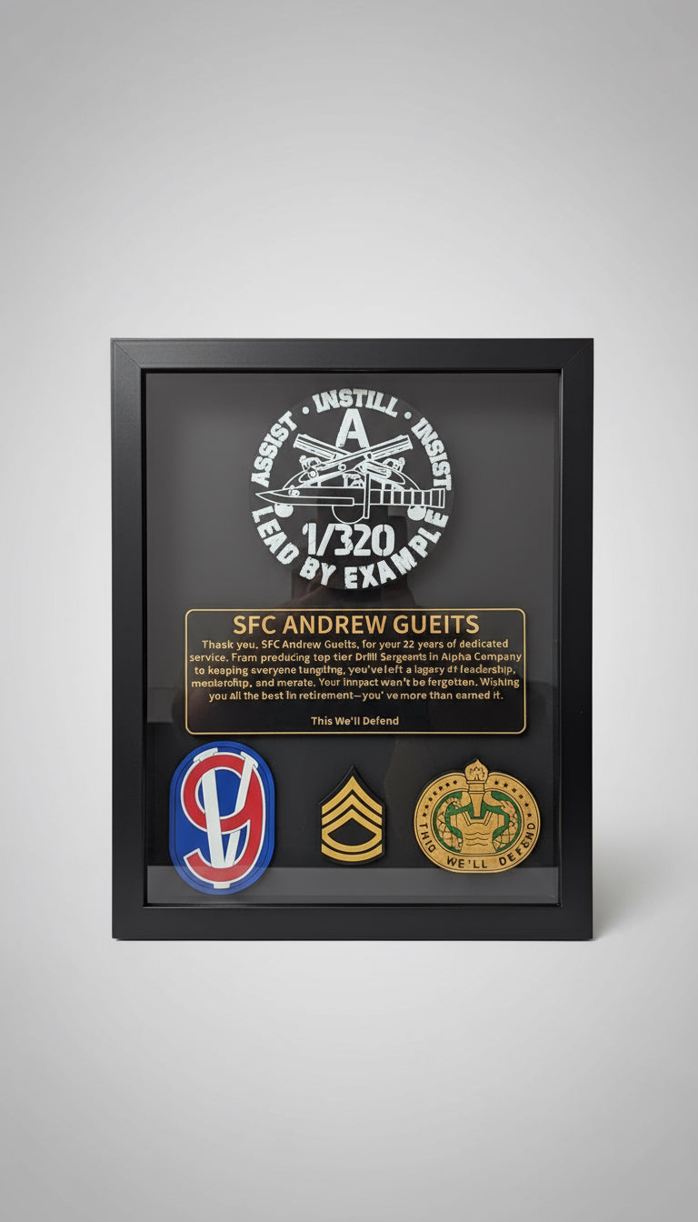 Framed military plaque with various insignias and text on a wooden surface