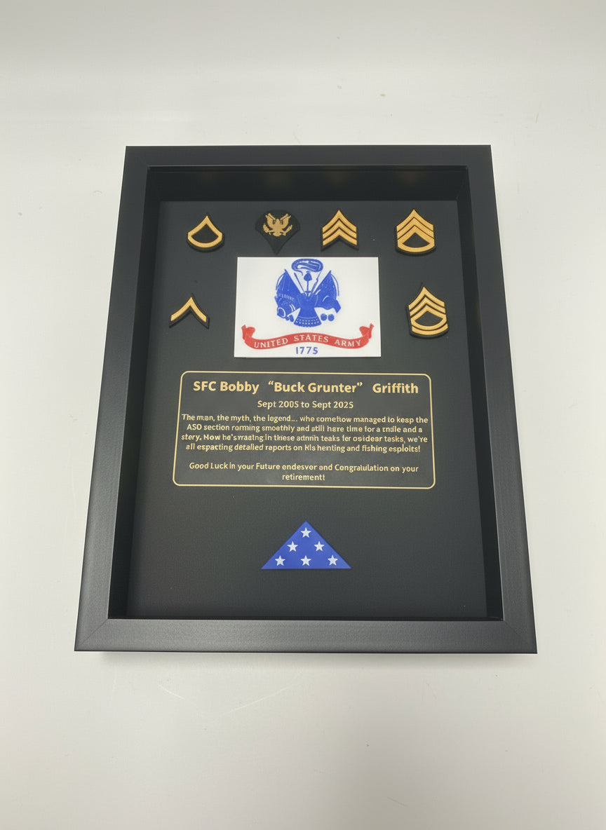 Framed military plaque with insignia and text on a black background