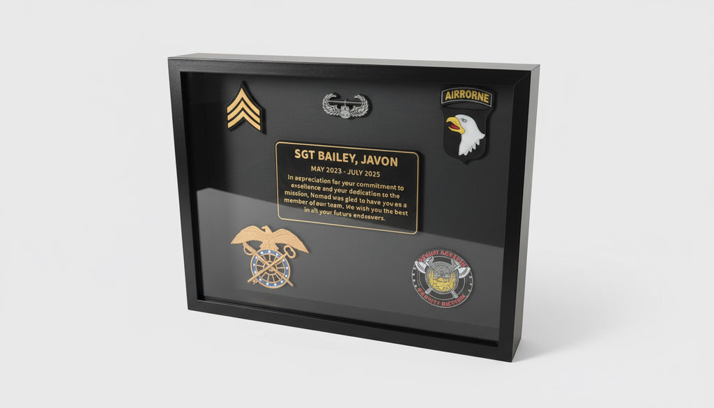 Framed military plaque with insignias and text on a table