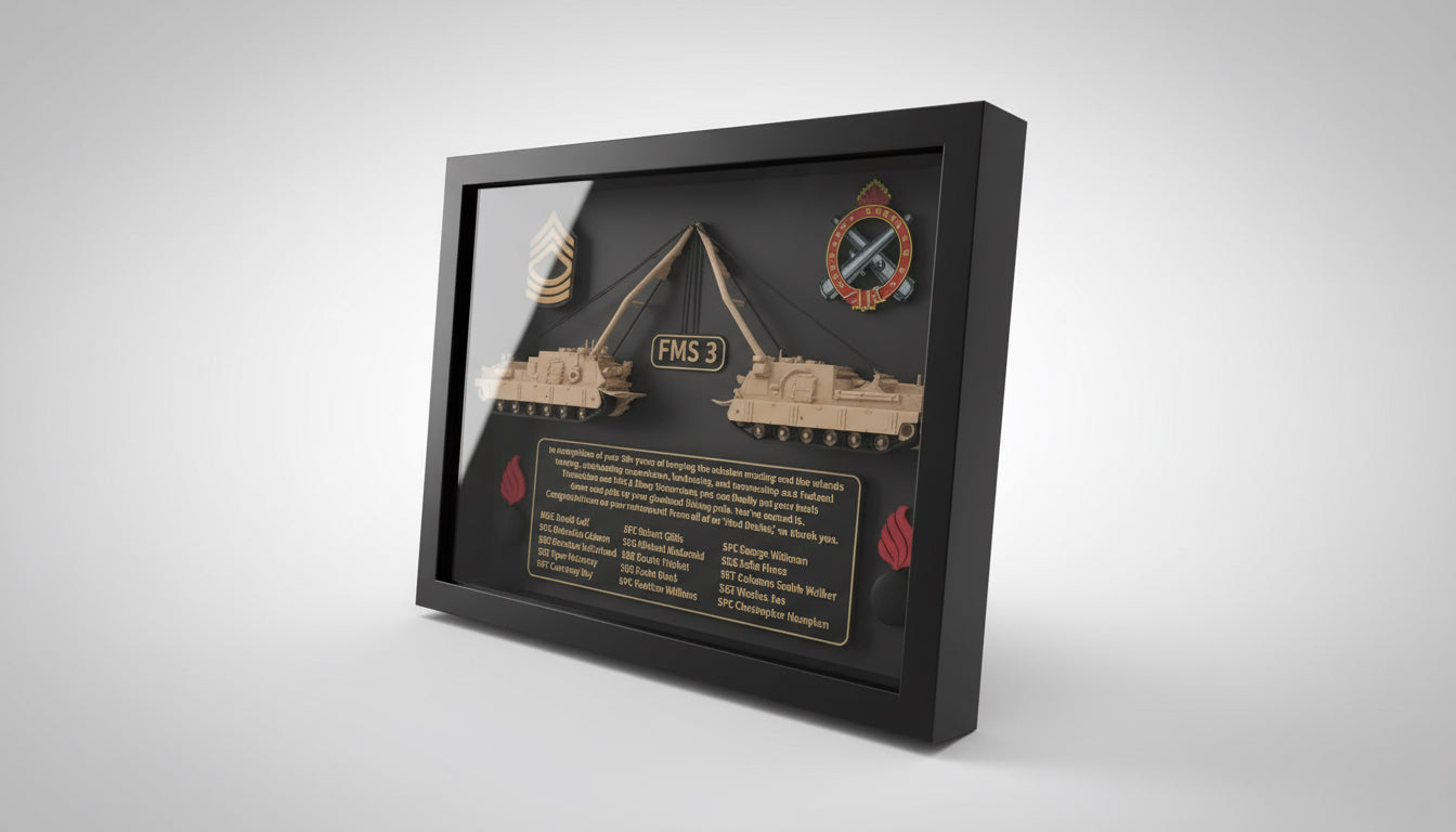 Framed military-themed display with tank models and text on a desk.