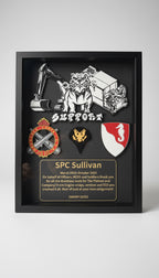 Framed award or recognition plaque held by a hand, featuring graphics and text.
