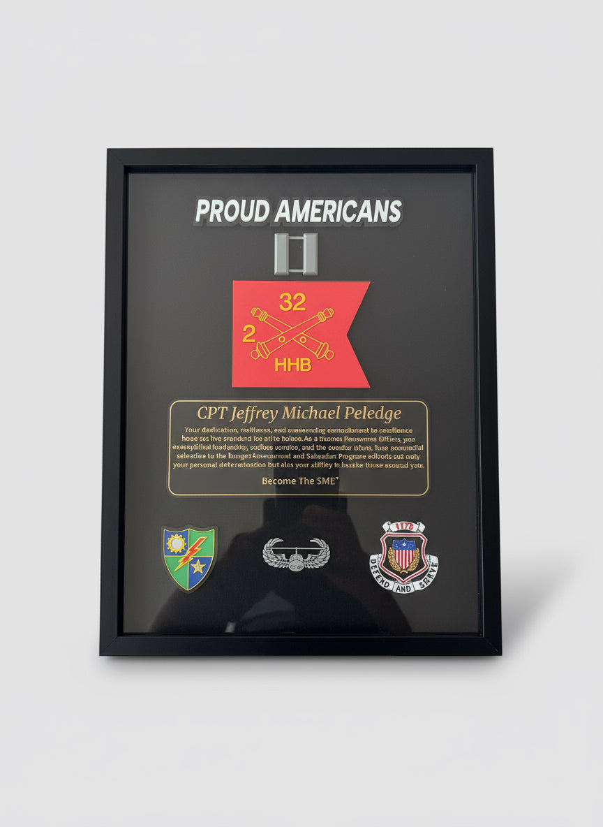 Framed plaque with 'Proud Americans' text and various insignias held by a person.